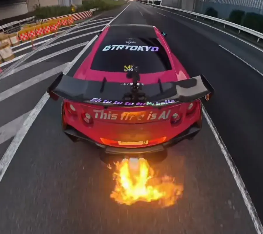 Pink Nissan GT-R R35 shooting backfire flames on an expressway